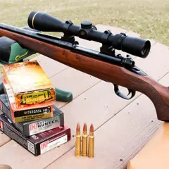 Carabine avec lunette, boîtes de munitions 338 Win Mag et cartouches, prête pour la chasse au chevreuil.