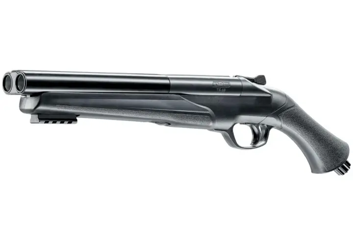 Un fusil à double canon, une arme de défense discrète, avec une poignée texturée et un rail sous le canon.